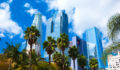 Ares’ Benjamin: ‘To get the business to the next step, I want a partner’ Los Angeles downtown skyscrapers with palm trees and Pershing Square in the foreground with clouds and a blue sky in the background