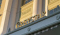 Greystar closes 11th fund in US value-add series Greystar's logo on the facade of its office, illuminated by sunlight at sunset.