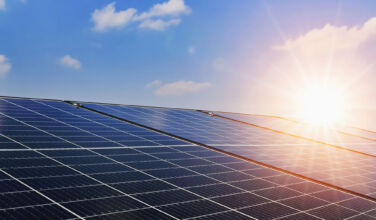 Energy costs bring renewables into sharper focus Solar panels with sunset and blue sky background. Clean power energy concept