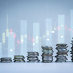 Image of stacks of coins in increasing order with faded statistics in the background.