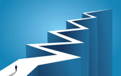 An illustration of a businessperson standing at the beginning of a long, zig-zagging road
