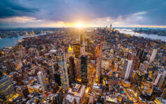 Real estate broker-owned managers face further growth headwinds Aerial photo of New York City at sunset.