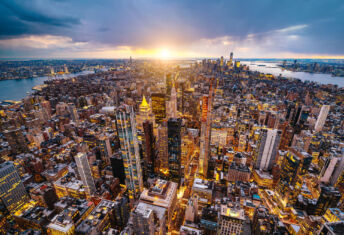 Real estate broker-owned managers face further growth headwinds Aerial photo of New York City at sunset.