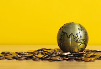 Asia-Pacific debt markets slowly diversify Gold globe with Asia showing laying on gold coins.