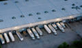 Aerial shot of large semi-trucks parked in a warehouse in Houston, Texas in the evening.
