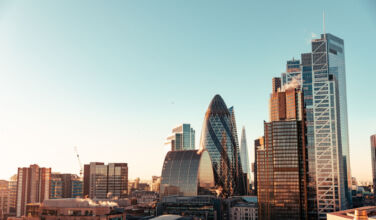 King Street appoints senior adviser to European real estate business Wide angle of sun setting over London Gherkin.