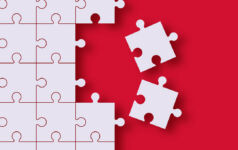 Two pieces of a jigsaw are removed from the rest of the jigsaw