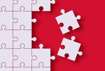 Two pieces of a jigsaw are removed from the rest of the jigsaw