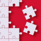Two pieces of a jigsaw are removed from the rest of the jigsaw
