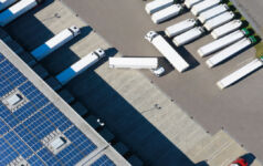 Image of trailers in and leaving a warehouse.