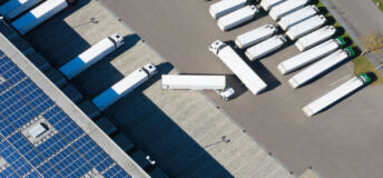 Image of trailers in and leaving a warehouse.