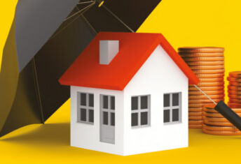 Image of a house under an umbrella next to coins.