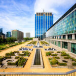 Owner of Belgiumโs biggest office sues CBRE Loan Services in valuation dispute Image of a glass building in central Belgium