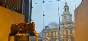 The Liberty Bell displayed at Liberty Bell Center located in Independence National Historical Park in Philadelphia Pennsylvania. Independence Hall can be seen in the background.