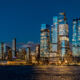 Prologis CIO joins Tishman Speyer to lead global expansion Wide view of Hudson Yards skyline and Vessel at night. Panoramic night shot of Manhattan west side with illuminated Vessel and Hudson Yards modern skyscrapers.